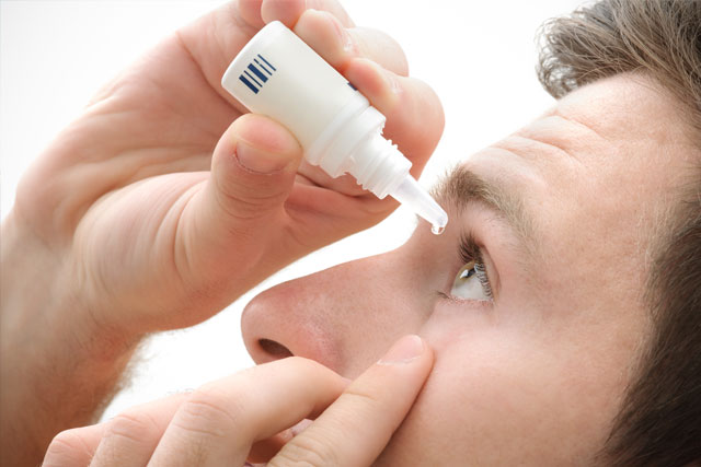 Man using eye drops for dry eye